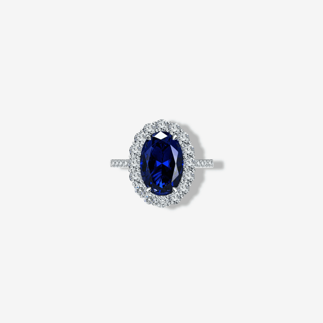 Product shot of oval Ceylon blue sapphire showing the halo setting and micro pavé silver band