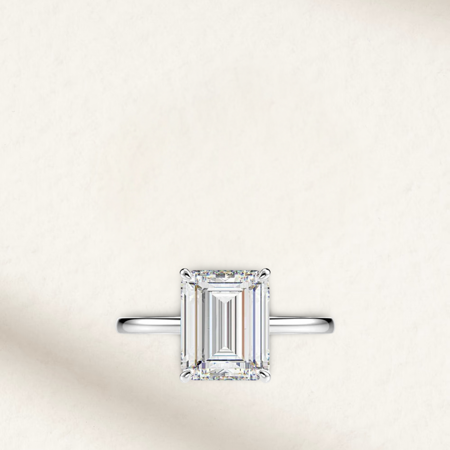 Emerald cut engagement ring inspired by Sofia Richie, featuring a radiant illusion white diamond set in sterling silver prongs with a classic silver band