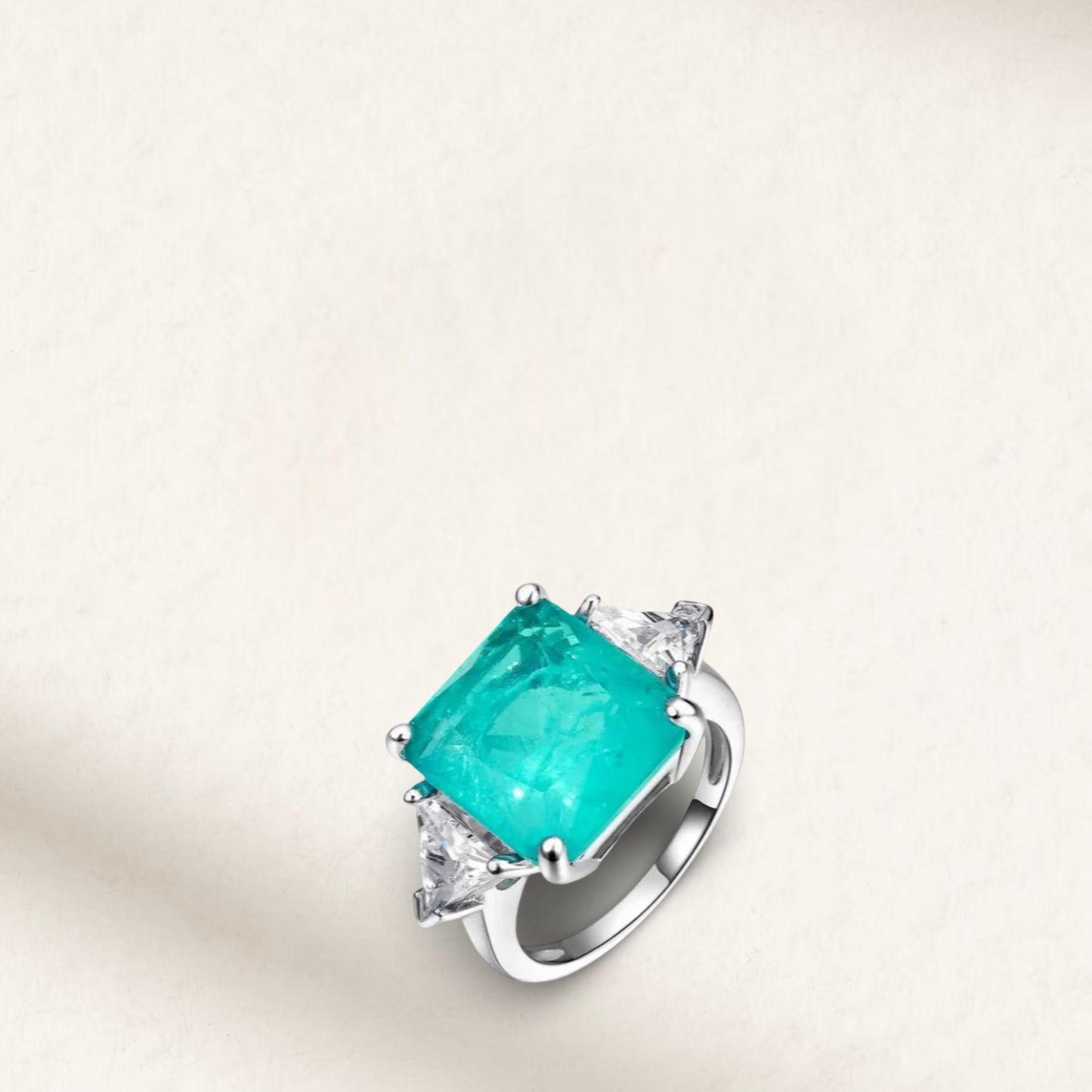 3 Carat Brazilian Paraiba Tourmaline boho engagement ring with square-cut center stone and pear side stones on sterling silver band