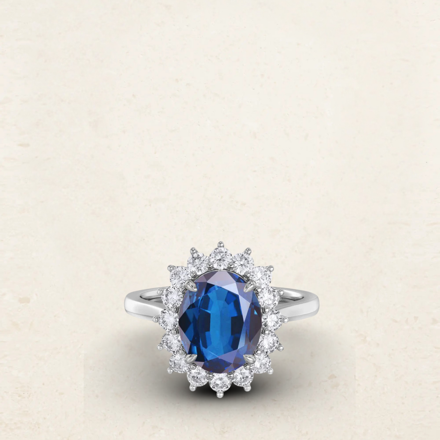 Princess Diana-inspired engagement ring dupe featuring a deep blue oval sapphire surrounded by a halo of sparkling diamonds in a classic silver setting.