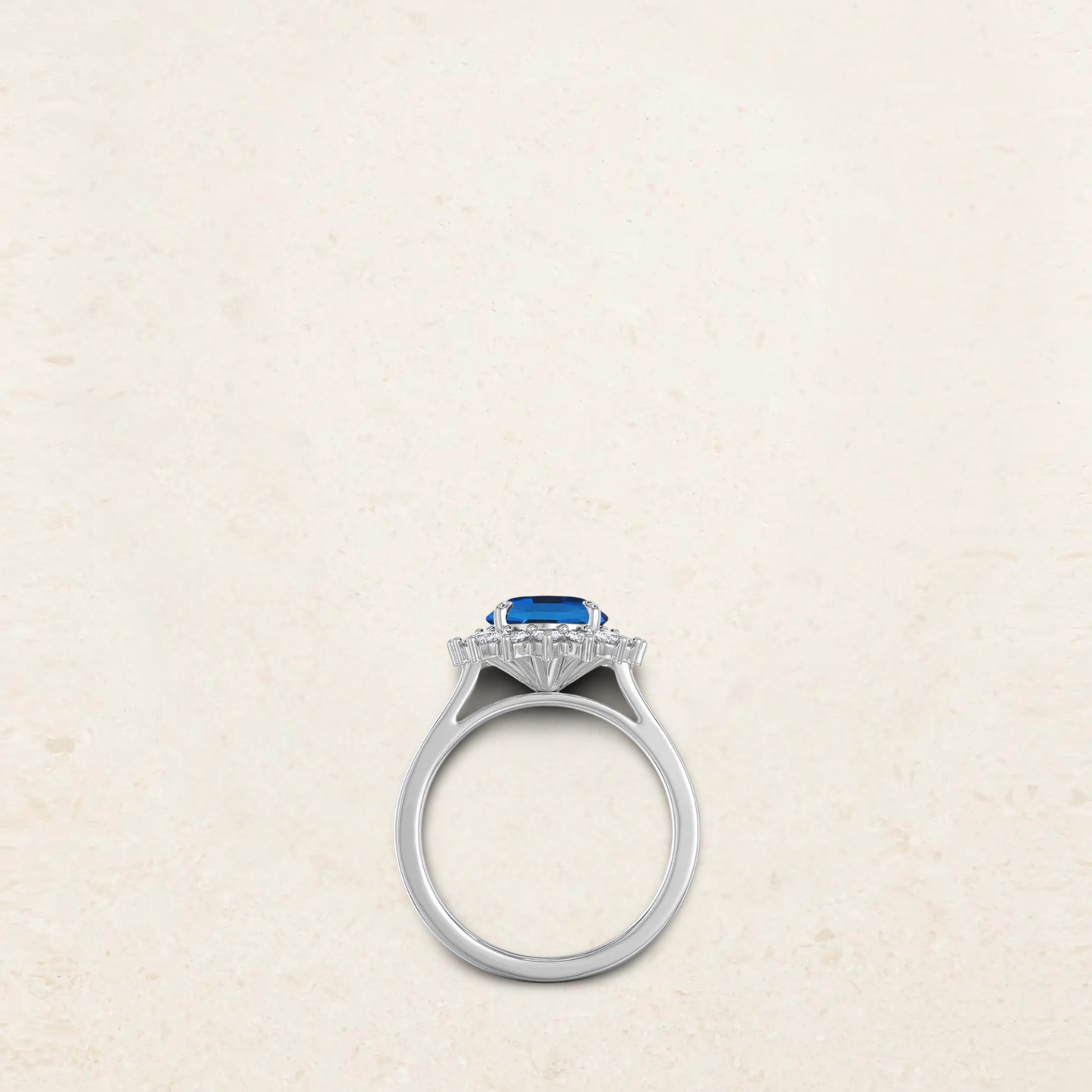 Princess Diana-inspired engagement ring dupe featuring a deep blue oval sapphire surrounded by a halo of sparkling diamonds in a classic silver setting side view