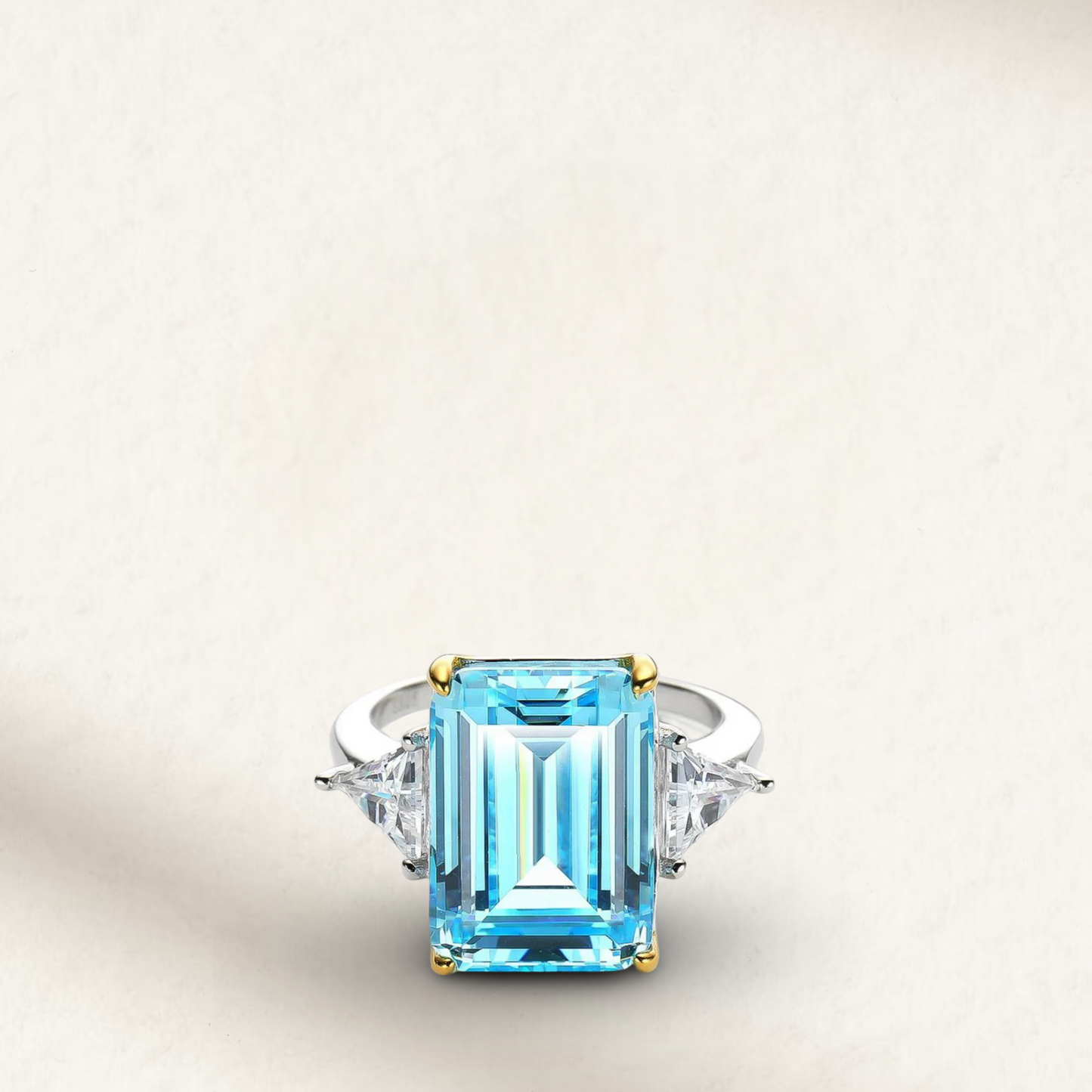 Princess Diana-inspired aquamarine ring featuring a large emerald-cut light blue gemstone set in a sleek silver band with diamond accents.