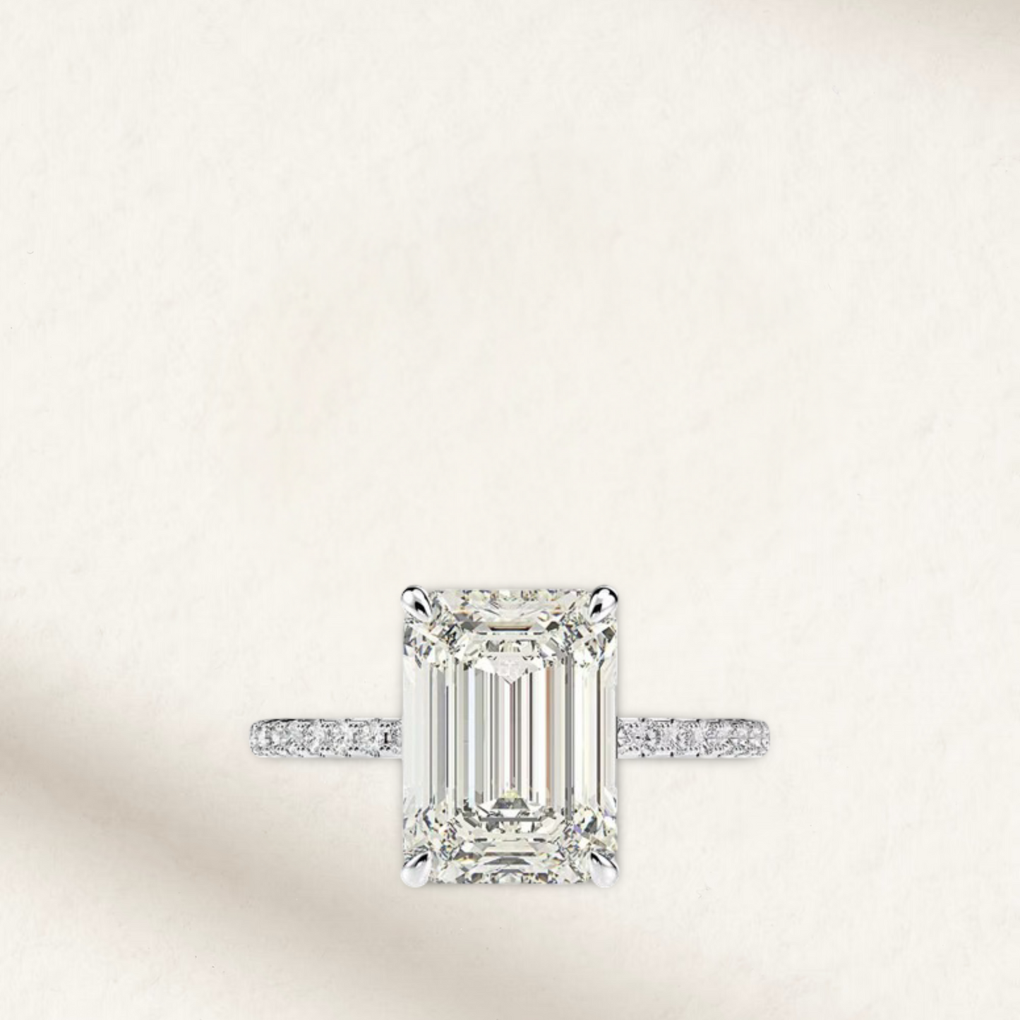Nicola Peltz-inspired engagement ring featuring an emerald-cut center stone with tapered baguette side stones set in polished sterling silver – a timeless, vintage-style design with modern elegance.