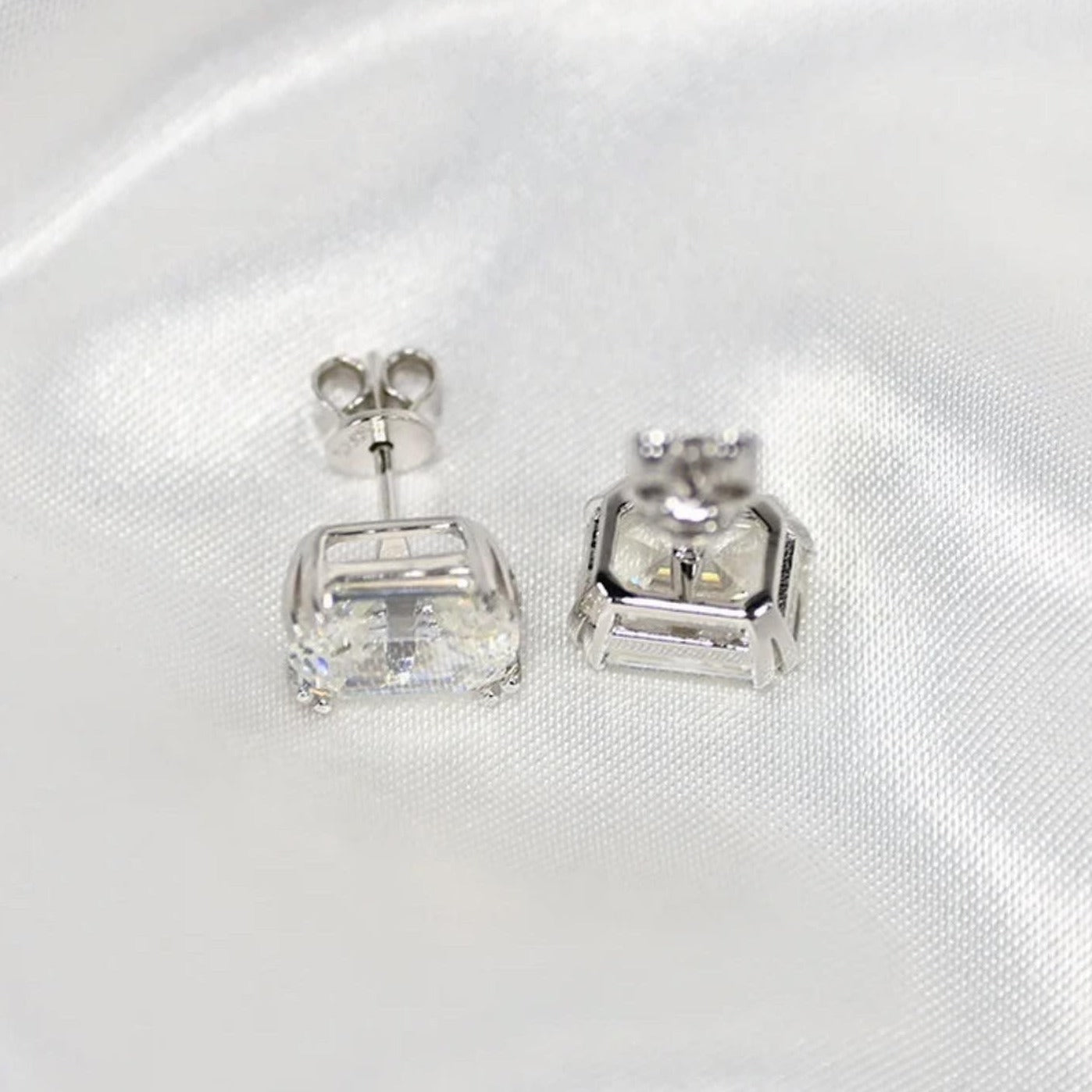 Our timeless, Emerald cut, sterling silver studs weighing 3 carats each, 8mm x 10mm stones. Our beautiful earrings are an elegant option for bridal jewellery or a special anniversary gift! Boxed and ready to go, these diamond earrings enhance any outfit close up by Margalit Rings