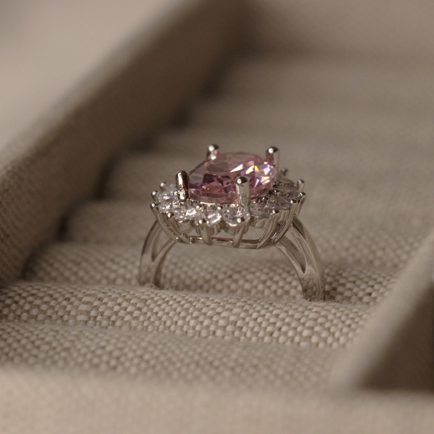 Our large pink oval sapphire set in a round diamond halo is reminiscent of a daisy is in the style of Lady Gaga's pink sapphire engagement ring given to her by Christian Carino.
