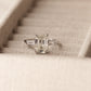 5 Carat Emerald Cut Engagement Ring with tapered baguettes on a 925 Sterling Silver band makes the perfect promise ring or proposal ring for her by margalit rings travel ring front
