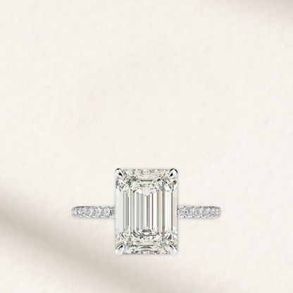 Nicola Peltz-inspired engagement ring featuring an emerald-cut center stone with tapered baguette side stones set in polished sterling silver – a timeless, vintage-style design with modern elegance.