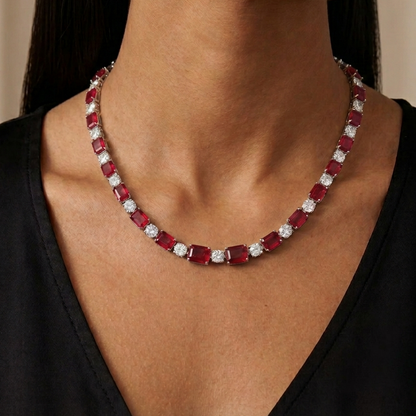 Ruby and diamond necklace on a model against a neutral background