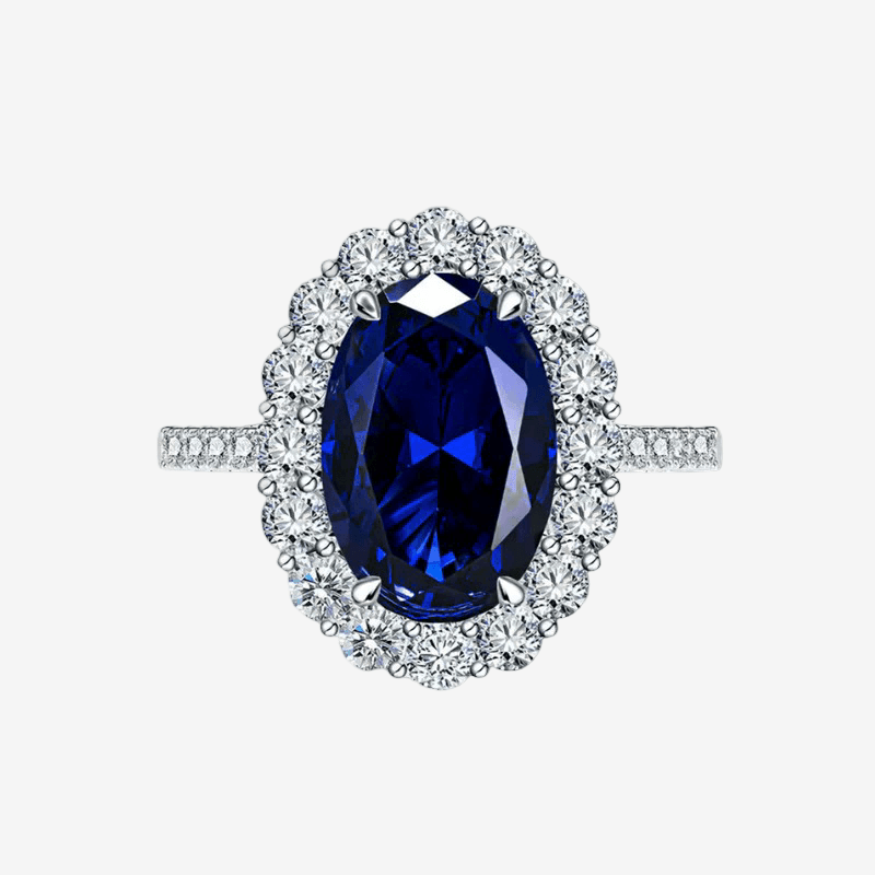 Kate Middleton engagement ring replica — 3 carat oval blue sapphire with diamond halo on a sterling silver band