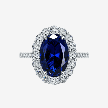 Kate Middleton engagement ring replica — 3 carat oval blue sapphire with diamond halo on a sterling silver band
