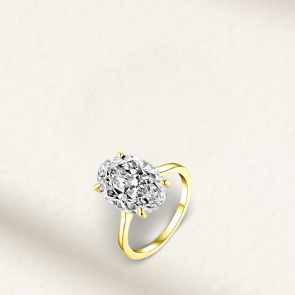 Jasmine Tookes-inspired 6 Carat oval cut engagement ring with brilliant white lab-created gemstone, prong set in yellow gold

