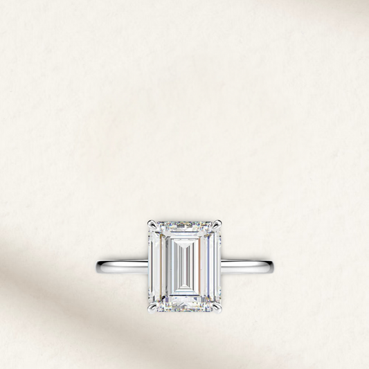 Emerald cut engagement ring inspired by Sofia Richie, featuring a radiant illusion white diamond set in sterling silver prongs with a classic silver band
