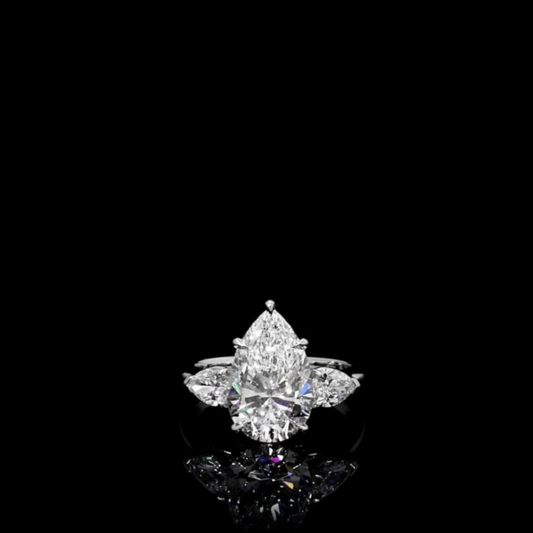 5.75 Carat pear shape engagement ring inspired by Jessica Simpson, featuring a white brilliant center stone flanked by two 0.75 carat pear cut stones in a three-stone sterling silver setting
