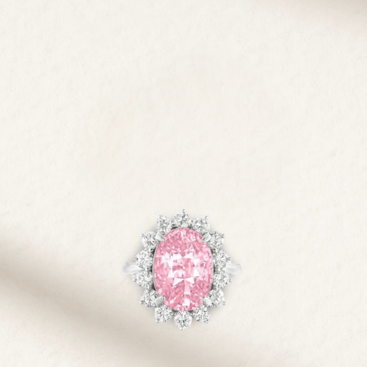 Lady Gaga inspired 9 Carat pink oval sapphire engagement ring with round brilliant accents and sterling silver band
