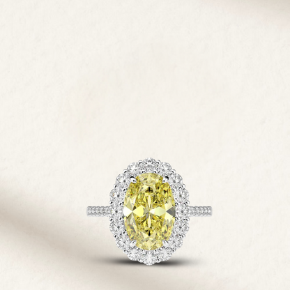 5 Carat fancy yellow oval engagement ring with round diamond accents on silver band