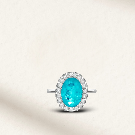 6 Carat oval cut Brazilian Paraiba tourmaline cocktail ring with trillion halo and sterling silver band