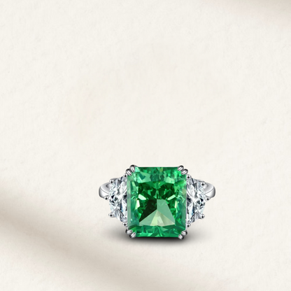 9 Carat emerald green cushion cut engagement ring set on a polished sterling silver band with vibrant gemstone brilliance