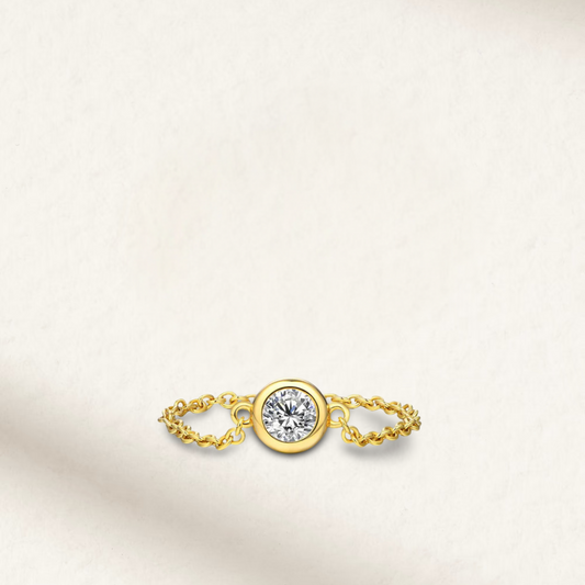 Bezel set solitaire ring with 1 carat diamond simulant in yellow gold plated sterling silver, showcasing sleek modern design.