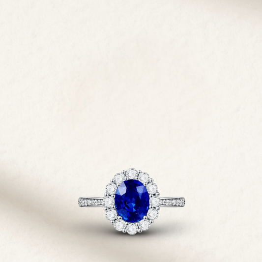 2 carat blue sapphire engagement ring inspired by Princess Diana, featuring an oval sapphire center stone with a diamond halo in a classic silver setting