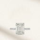 Nicola Peltz-inspired engagement ring featuring an emerald-cut center stone with tapered baguette side stones set in polished sterling silver – a timeless, vintage-style design with modern elegance.