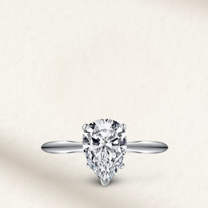 2 carat lab-made pear-shaped engagement ring set in sterling silver, featuring a modern and elegant bridal design.