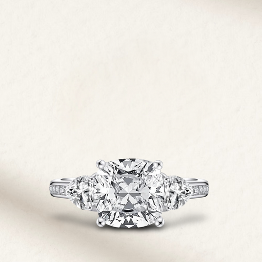 5 carat cushion cut engagement ring with white brilliant stone, three-stone demi channel setting, and 925 sterling silver band.