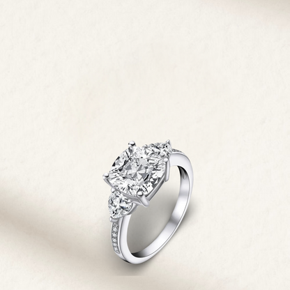 5 carat cushion cut engagement ring with white brilliant stone, three-stone demi channel setting, and 925 sterling silver band.