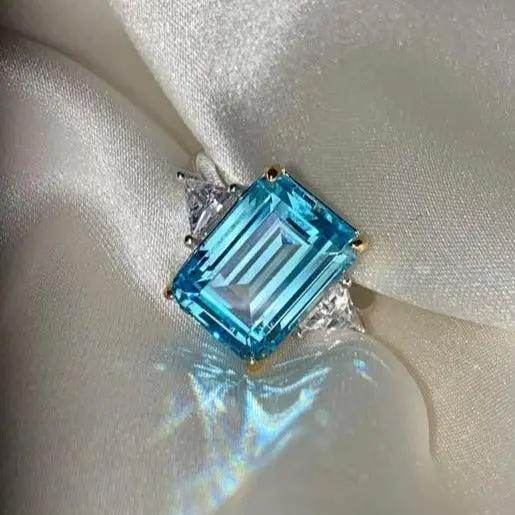 Princess Diana Aquamarine Ring Replica product shot on silk background, 8.48 Carat, Emerald Cut - MargalitRings