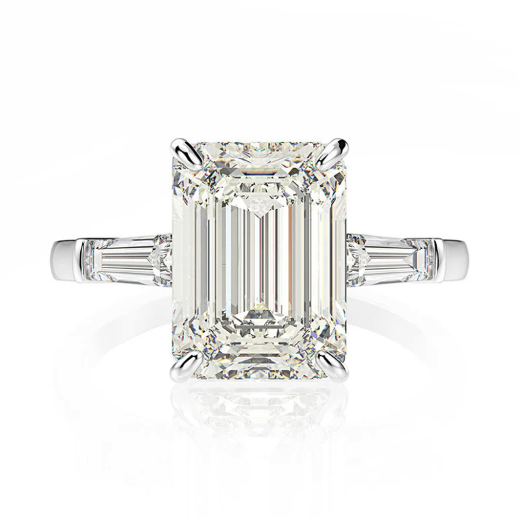 side view Our exceptional 5 Carat Emerald Cut Engagement Ring makes the perfect promise ring or proposal ring for her! Boxed and ready to go, our emerald cut ring will make the perfect gift for her. The centre stone is flanked by tapered baguettes in a truly timeless fashion by Margalit Rings