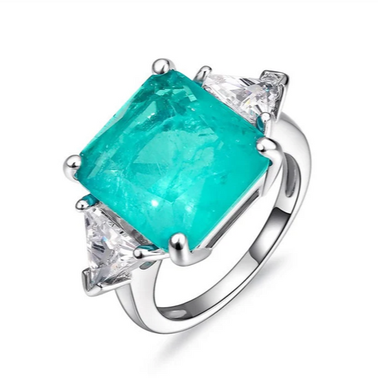 Our stunning 3 Carat Brazilian Paraiba, Tourmaline and Diamond Gemstone Engagement Ring flanked by two 0.7ct trillions on a 100% 925 Sterling Silver band by Margalit Rings